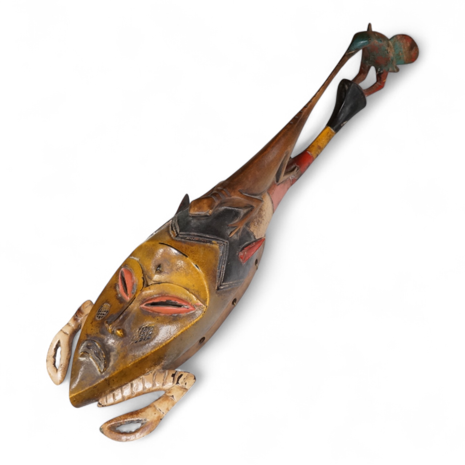 An early 20th century Tribal carved and painted mask from the Ivory Coast, 74cm in length